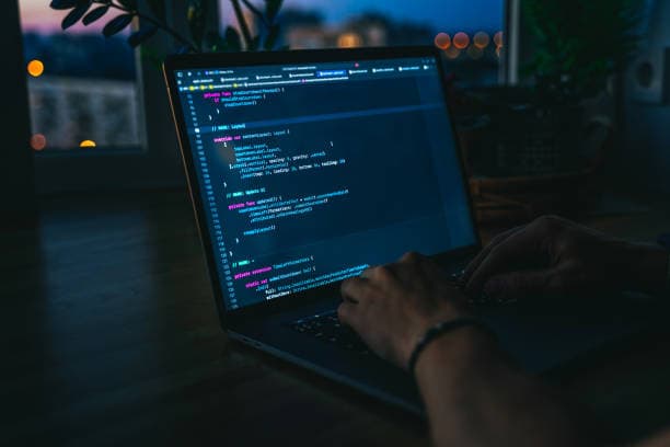 Laptop showing website code, symbolising website development and cloud services
